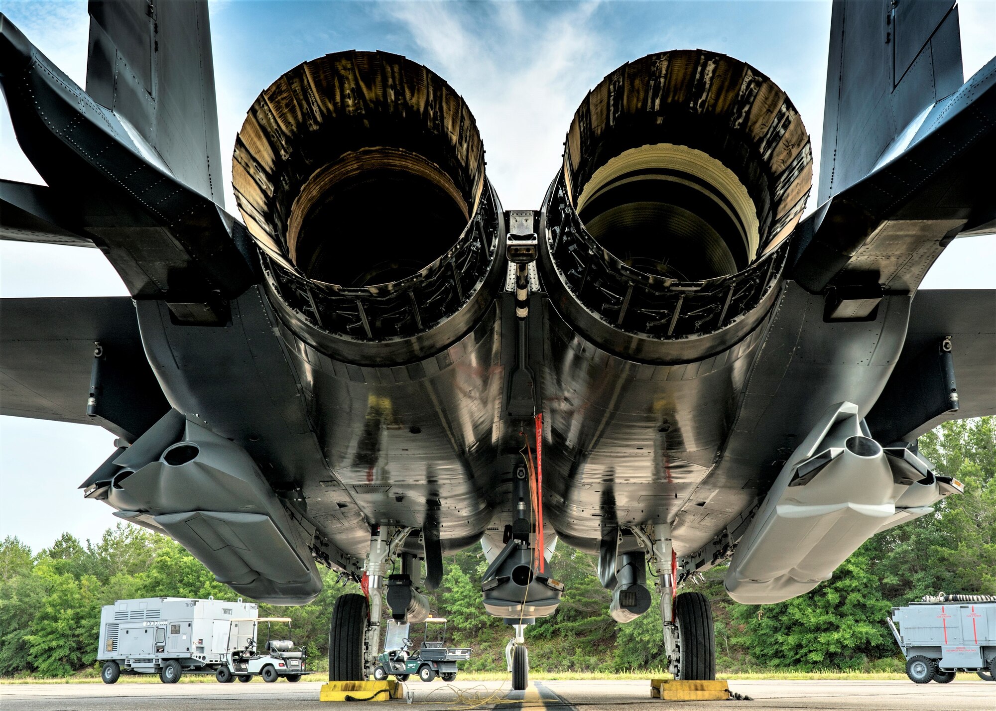 An F-15E Strike Eagle sits on the ramp with five JASSMs loaded