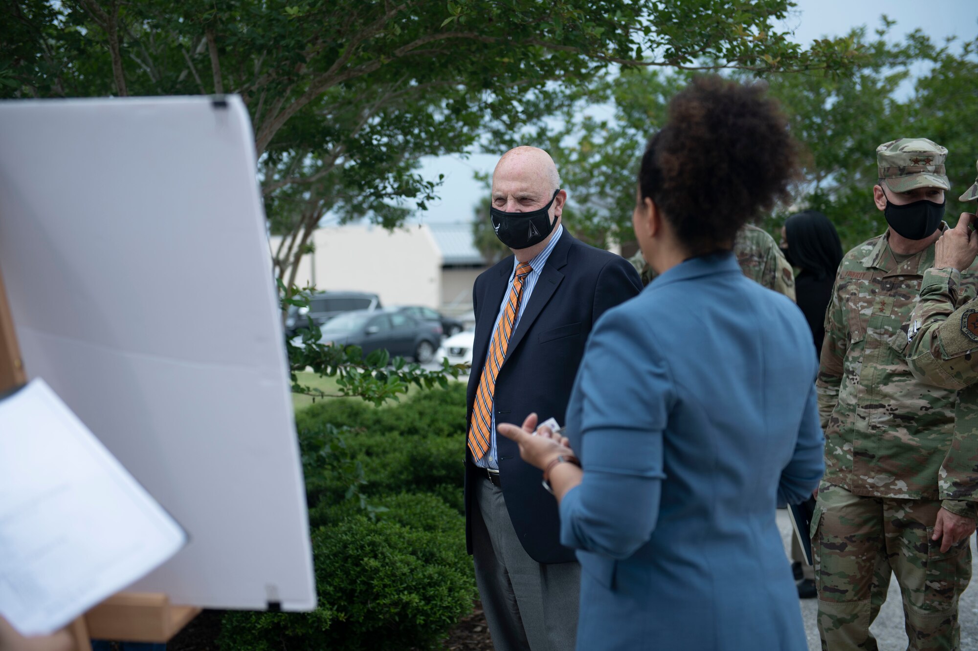 Woman presents visual plans to a man