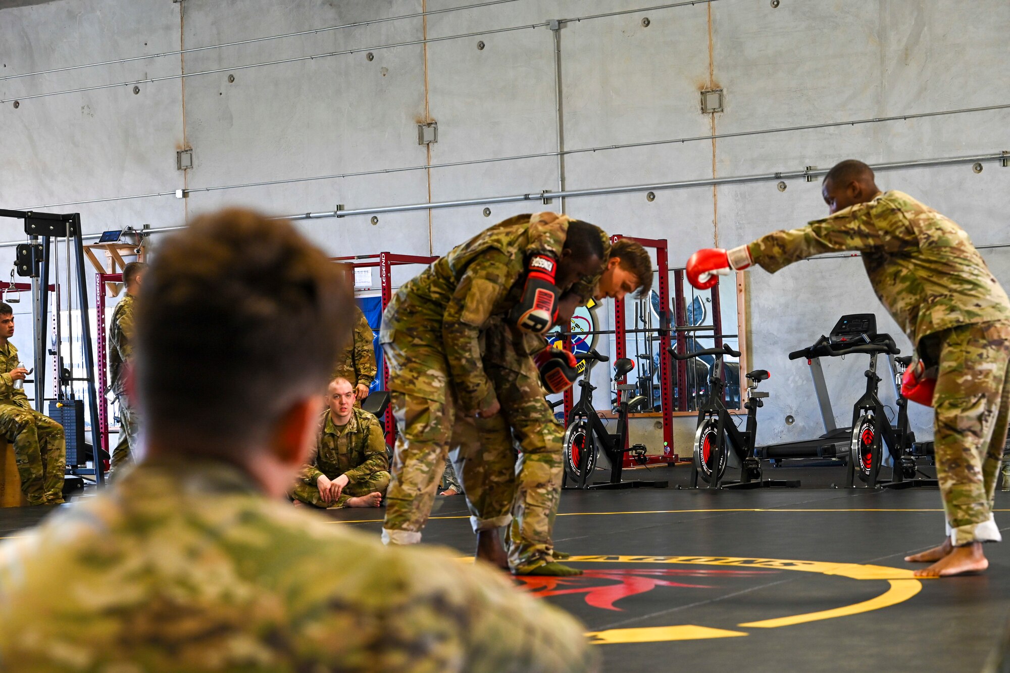 Dragon Forge participants look on during the combatives demonstration of exercise Dragon Forge on North West Field, Guam, April 9, 2021. Exercise DF is a combat skills training course that prepares participants to deploy to austere locations. (U.S. Air Force photo by Tech. Sgt. Esteban Esquivel)