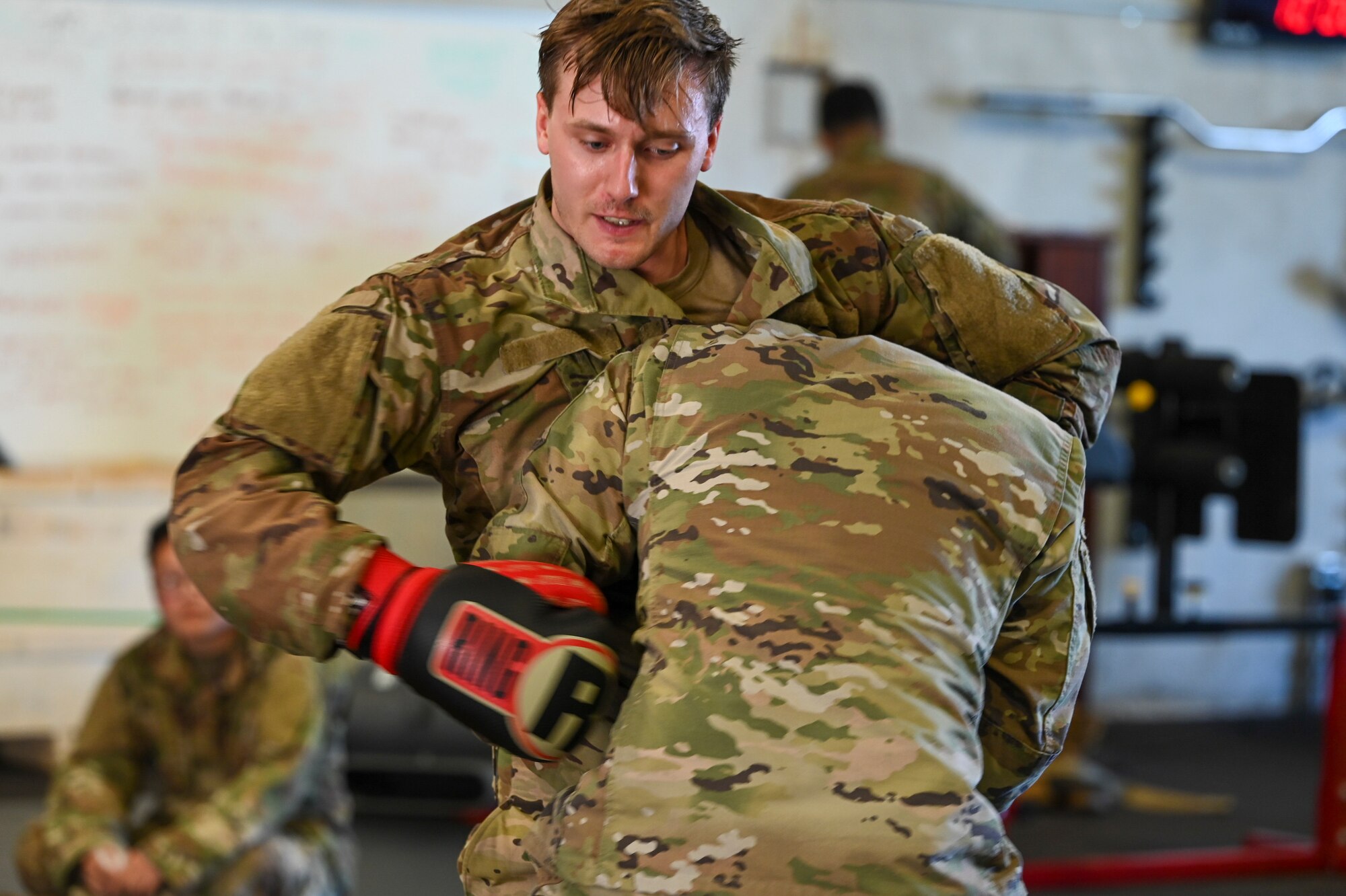 U.S. Air Force Staff Sgt. Brandon Tonnar, combat readiness school instructor assigned to the 644th Combat Communications Squadron, tests a student’s response to being attacked on North West Field, Guam, April 9, 2021. Tonner was one of several instructors leading exercise Dragon Forge 2021. Exercise DF is a combat skills training course that prepares participants to deploy to austere locations. (U.S. Air Force photo by Tech. Sgt. Esteban Esquivel)