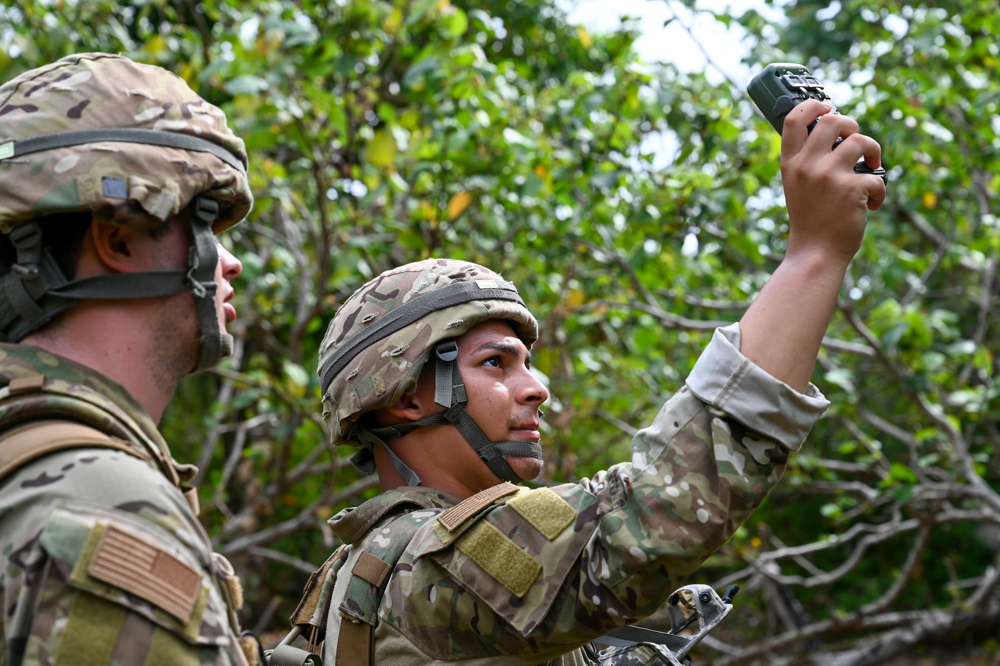 U.S. Air Force Airman 1st Class Adam Lixey and Airman 1st Class Brayan Rivera systems technicians assigned to the 644th Combat Communications Squadron, practice their land navigation skills during exercise Dragon Forge on North West Field, Guam, April 13, 2021. Exercise Dragon Forge is a combat skills training course that prepares participants to deploy to austere locations. (U.S. Air Force photo by Tech. Sgt. Esteban Esquivel)