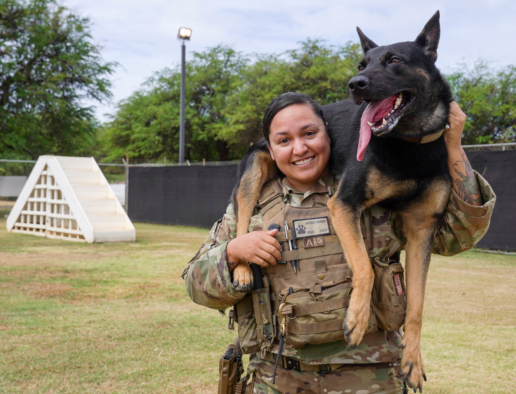 Staff Sgt. Alexis Fierro and Batman, 647th Security Forces military working dog handler and military working dog, train together at the obedience course at Joint Base Pearl Harbor-Hickam, Hawaii, May 7, 2021. Batman is a patrol explosive detection dog who worked with Fierro for a year. (U.S. Air Force photo by Airman 1st Class Makensie Cooper)
