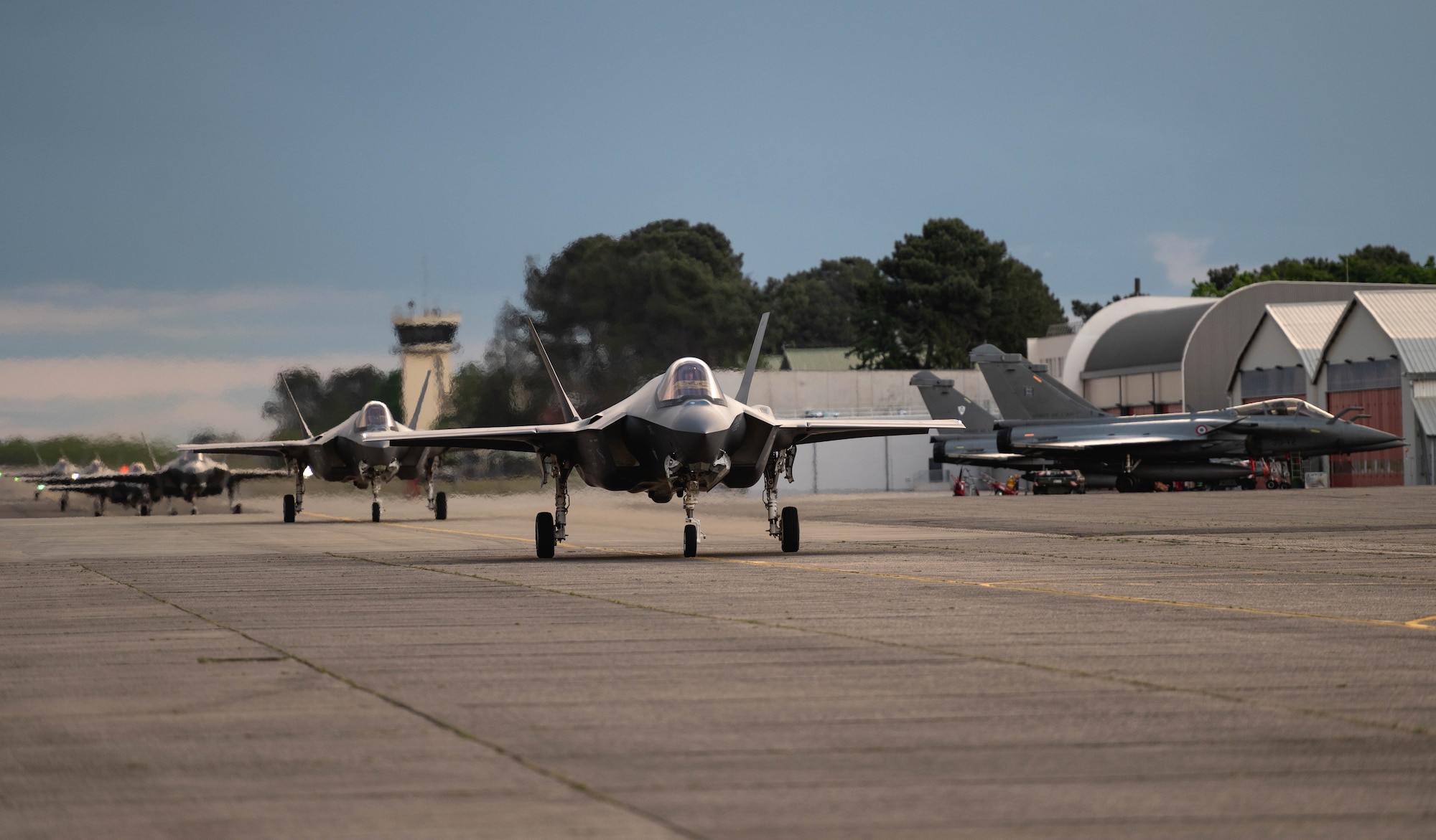 U.S. Air Force F-35A Lightning IIs assigned to the 4th Fighter Squadron, Hill Air Force Base, Utah, taxi down the flightline at Mont-de-Marsan Air Base, France, May 10, 2021. During their time in the European theater, the 4th FS aircraft will participate in multiple events, including Atlantic Trident 21, underscoring the steadfast U.S. commitment to the region and enhancing interoperability with NATO allies and partners. (U.S. Air Force photo by Staff Sgt. Alexander Cook)