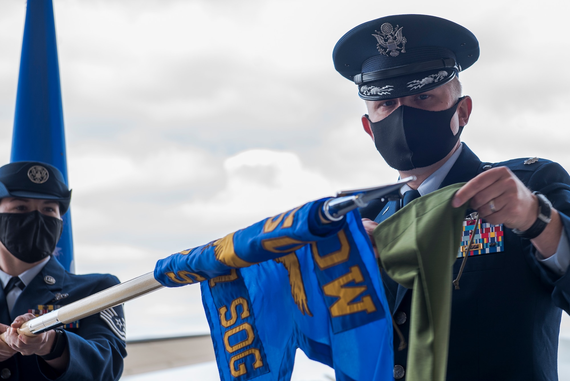 Air Force Lt. Col. Joshua Stinson, 310th Special Operations Squadron commander, puts away the guidon for the 27th Special Operations Detachment 1, at the 310 SOS activation ceremony at Cannon Air Force Base, N.M., May 4, 2021. The 310 SOS was activated recently to align with the Air Force Special Operations Command’s new deployment plans, providing a more sustainable and predictable deployment cycle to allow Air Commandos more time at home station to develop themselves and the culture of the squadron. (U.S. Air Force photo by Senior Airman Vernon R. Walter III)
