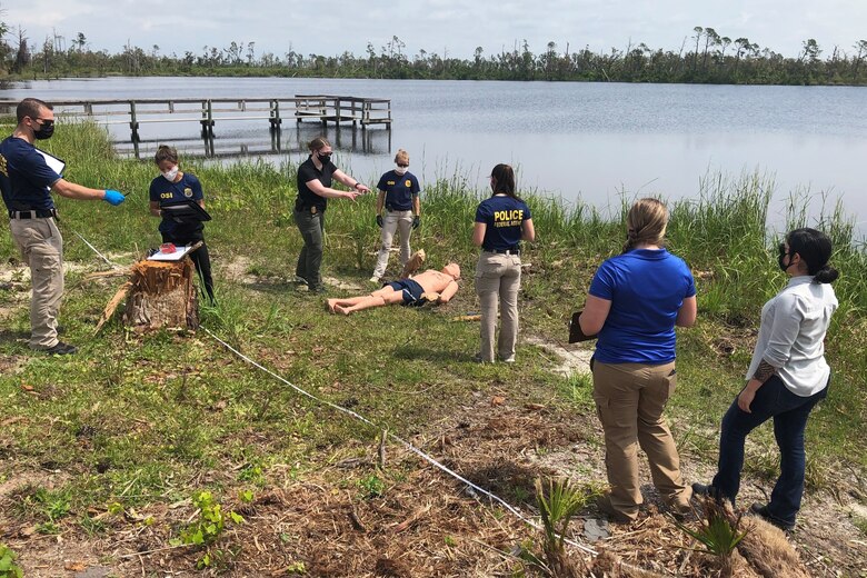 Special agents assigned to Office of Special Investigations Detachment 223 team with a 2nd Field Investigations Squadron forensic science consultant and investigators assigned to the 325th Security Forces Squadron Investigations, to process a crime scene scenario during an exercise at Tyndall Air Force Base, Fla., April 30, 2021.