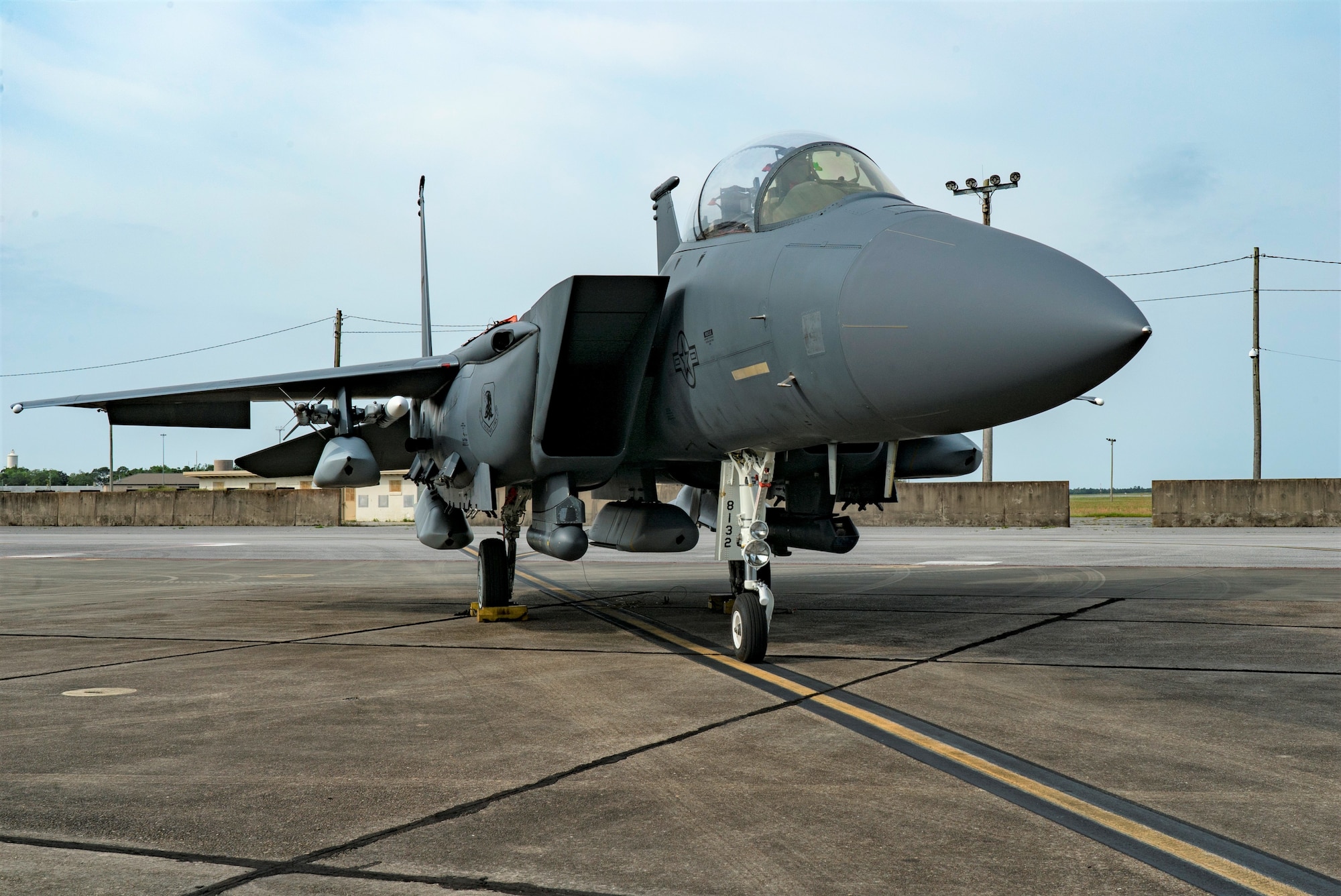 An F-15E Strike Eagle sits on the ramp with five JASSMs loaded