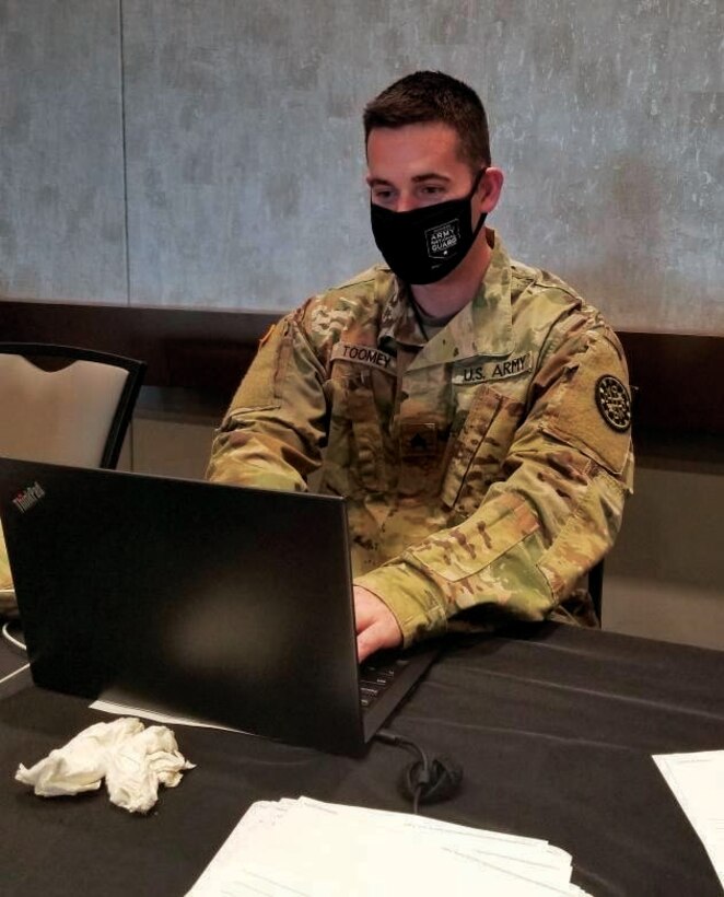 U.S. Army Sgt. John Toomey, assigned to the COVID-19 Vaccination Testing Team Task Force North, Michigan National Guard, conducts administrative procedures during a vaccination event in Marquette April 29, 2021.