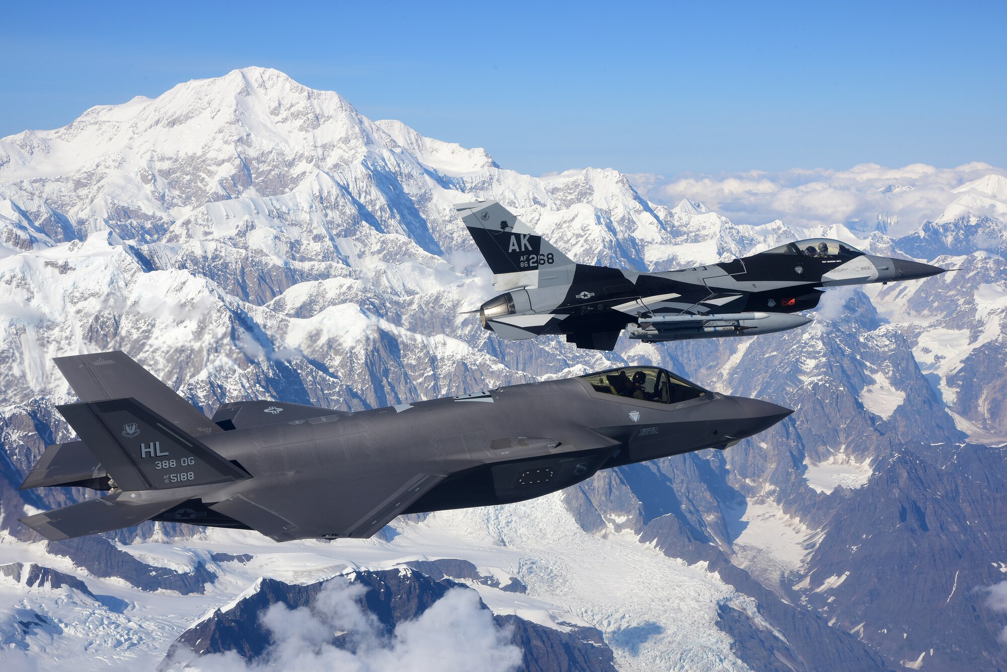 An F-35A Lightning II, assigned to the 388th Fighter Wing at Hill Air Force Base in Utah, and an F-16 Fighting Falcon, assigned to the 18th Aggressor Squadron at Eielson Air Force Base in Alaska, fly over Denali National Park, Alaska, Aug. 17, 2020. The 388th FW's F-35As made their debut in RED FLAG-Alaska 20-3 training alongside F-35As from the 356th Fighter Squadron at Eielson Air Force Base, Alaska. (U.S. Air Force photo by Tech. Sgt. Jerilyn Quintanilla)