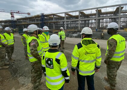 James O’Riley, U.S. Army Corps of Engineers Europe District project engineer and contracting officer’s representative, briefs Col. Brad Bane and Command Sgt. Maj. Kofie Primus, the 405th Army Field Support Brigade’s command team, at the new Army Prepositioned Stock-2 site in Powidz, Poland, which is under construction. When complete, the APS-2 site will be comprised of 650,000 square feet of humidity-controlled warehouse space, a vehicle maintenance facility and supporting facilities. Also, there will be 58,000 square foot earth-covered munitions storage area nearby.