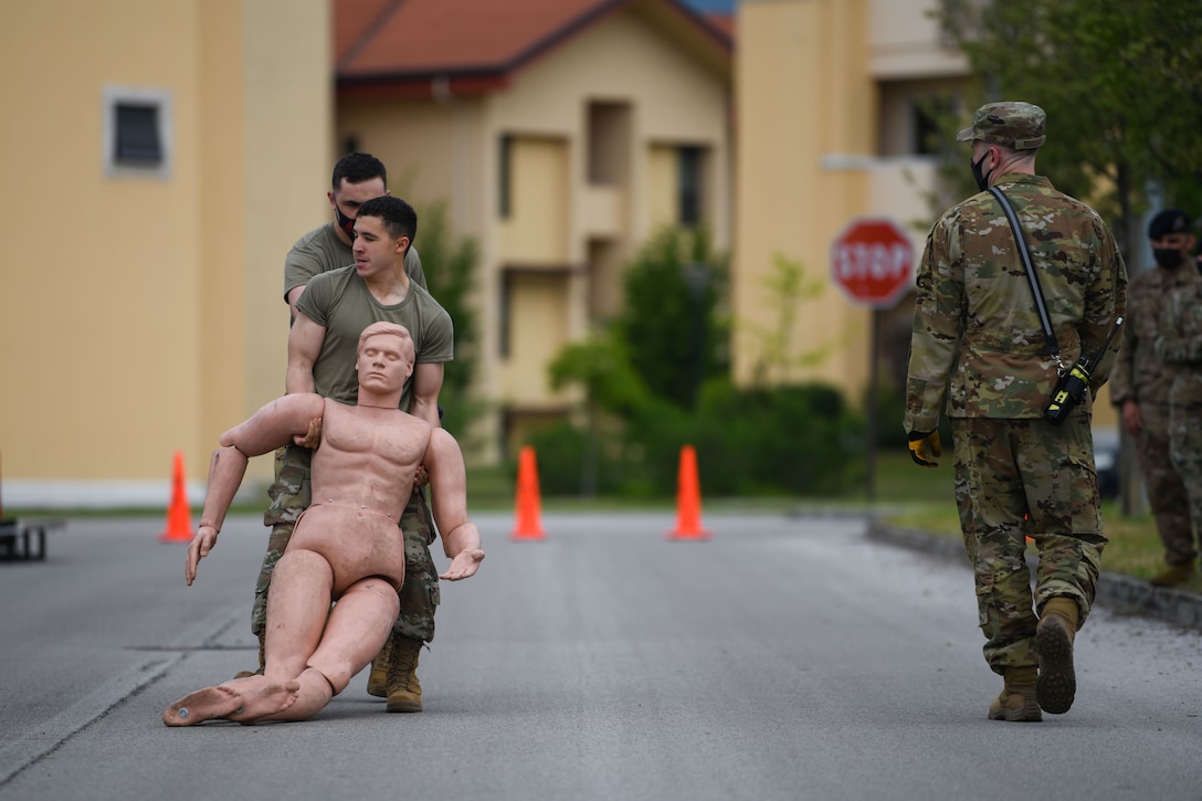 Airman Wesley J. Harding-Brown, 31st Security Forces Squadron (SFS) member, participate in a body drag for Police Week at Aviano Air Base, Italy, May 11, 2021. Airmen from the 31st SFS and 31st Civil Engineer Squadron competed in an obstacle course. The course consisted of a hose drag, litter carry, body drag, tire flips, Keiser FORCE Machine, sprints, M4 carbine assembly and disassembly, and a Humvee team push. (U.S. Air Force photo by Senior Airman Ericka A. Woolever)