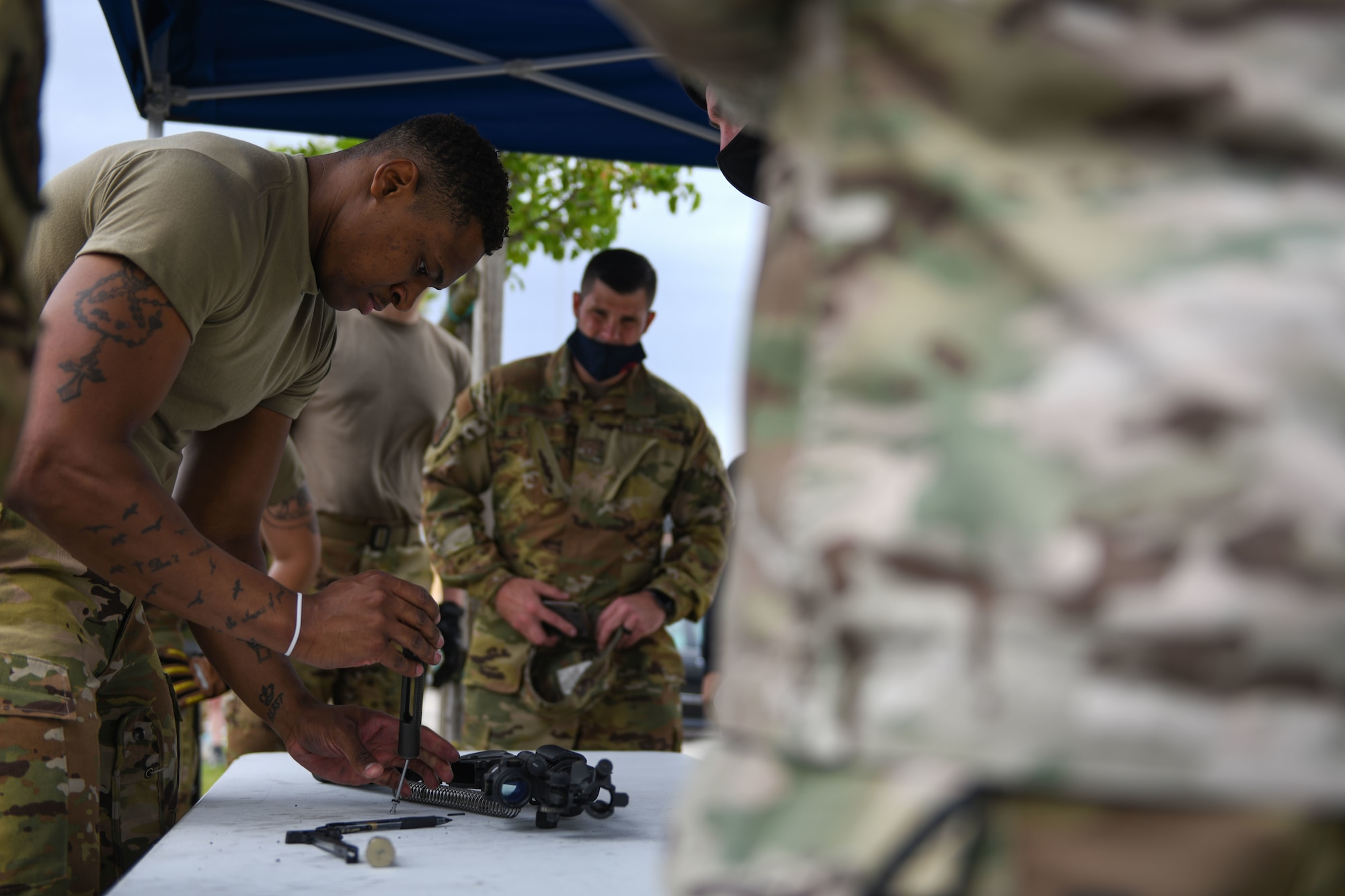 U.S. Air Force Staff Sgt. Philip Thompson, 31st Civil Engineer Squadron (CES) lead firefighter, disassembles an M4 carbine during Police Week at Aviano Air Base, Italy, May 11, 2021. Airmen from the 31st Security Forces Squadron and 31st CES competed in an obstacle course in honor of Police Week. Police Week recognizes the service and sacrifice of U.S. law enforcement members, paying special tribute to those who have lost their lives in the line of duty for the safety and protection of others. (U.S. Air Force photo by Senior Airman Ericka A. Woolever)