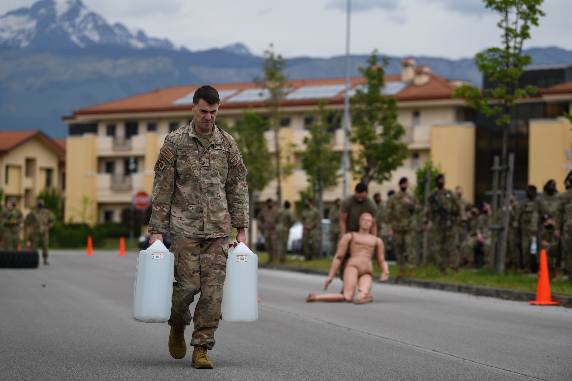 U.S. Air Force Staff Sgt. Austin Murray, 31st Security Forces Squadron (SFS) area supervisor, carries two jerry cans at Aviano Air Base, Italy, May 11, 2021. Airmen from the 31st SFS and 31st Civil Engineer Squadron competed in an obstacle course during Police Week. Police Week recognizes the service and sacrifice of U.S. law enforcement members, paying special tribute to those who have lost their lives in the line of duty for the safety and protection of others. (U.S. Air Force photo by Senior Airman Ericka A. Woolever)