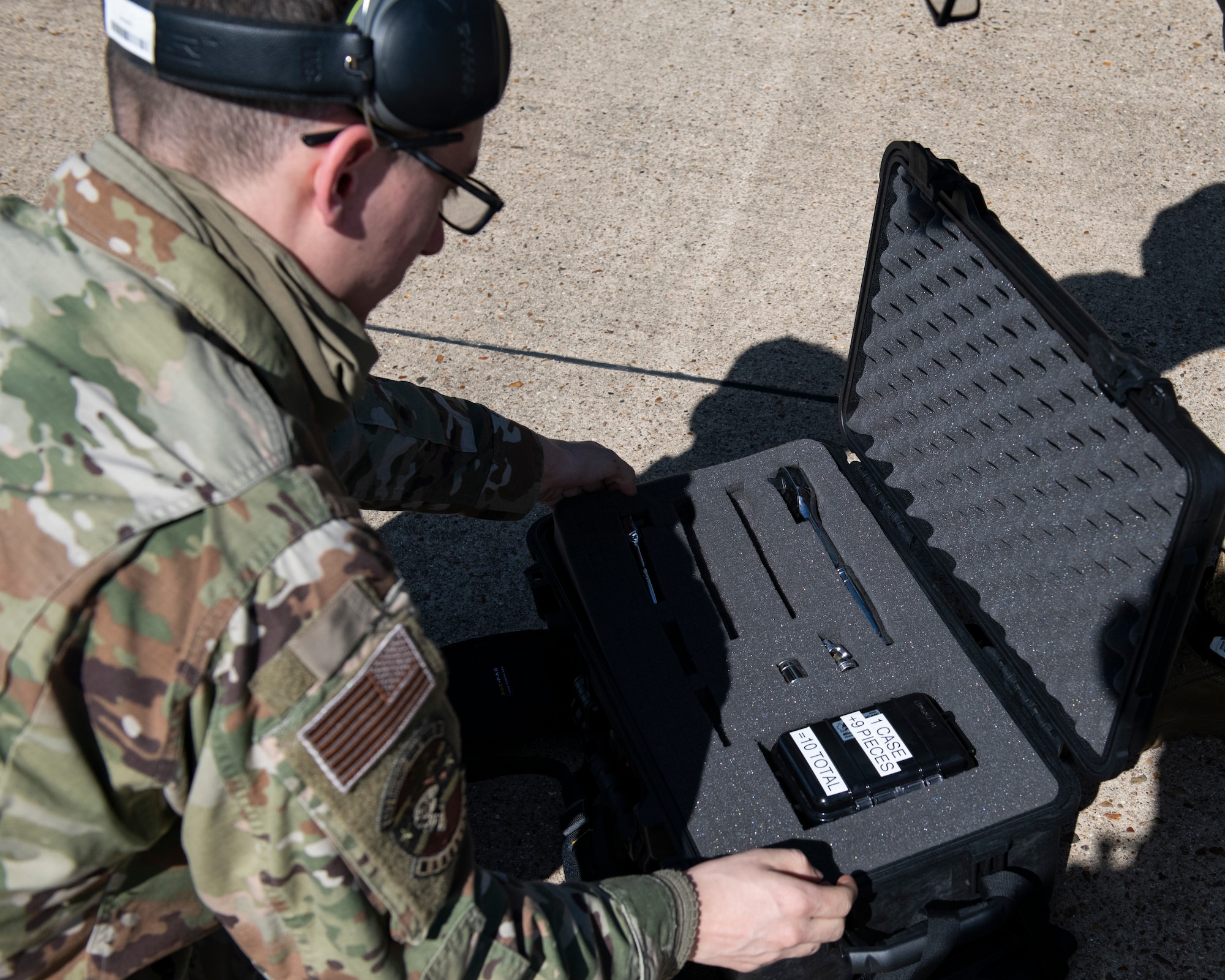 U.S. Air Force Airman 1st Class Aaron McClean, a weapons load crew member with the 492nd Aircraft Maintenance Unit, retrieves tools from a Theater Readiness Tactical Line Equipment pack at Royal Air Force Lakenheath, England, April 22, 2021. Designed to hold the minimal tools and equipment necessary to work on aircraft in a deployed environment, the lightweight backpack-style carriers weigh roughly 20 pounds, allowing Airman to carry and transport them to austere locations much easier than a full toolkit. (U.S. Air Force photo by Airman 1st Class Cedrique Oldaker)
