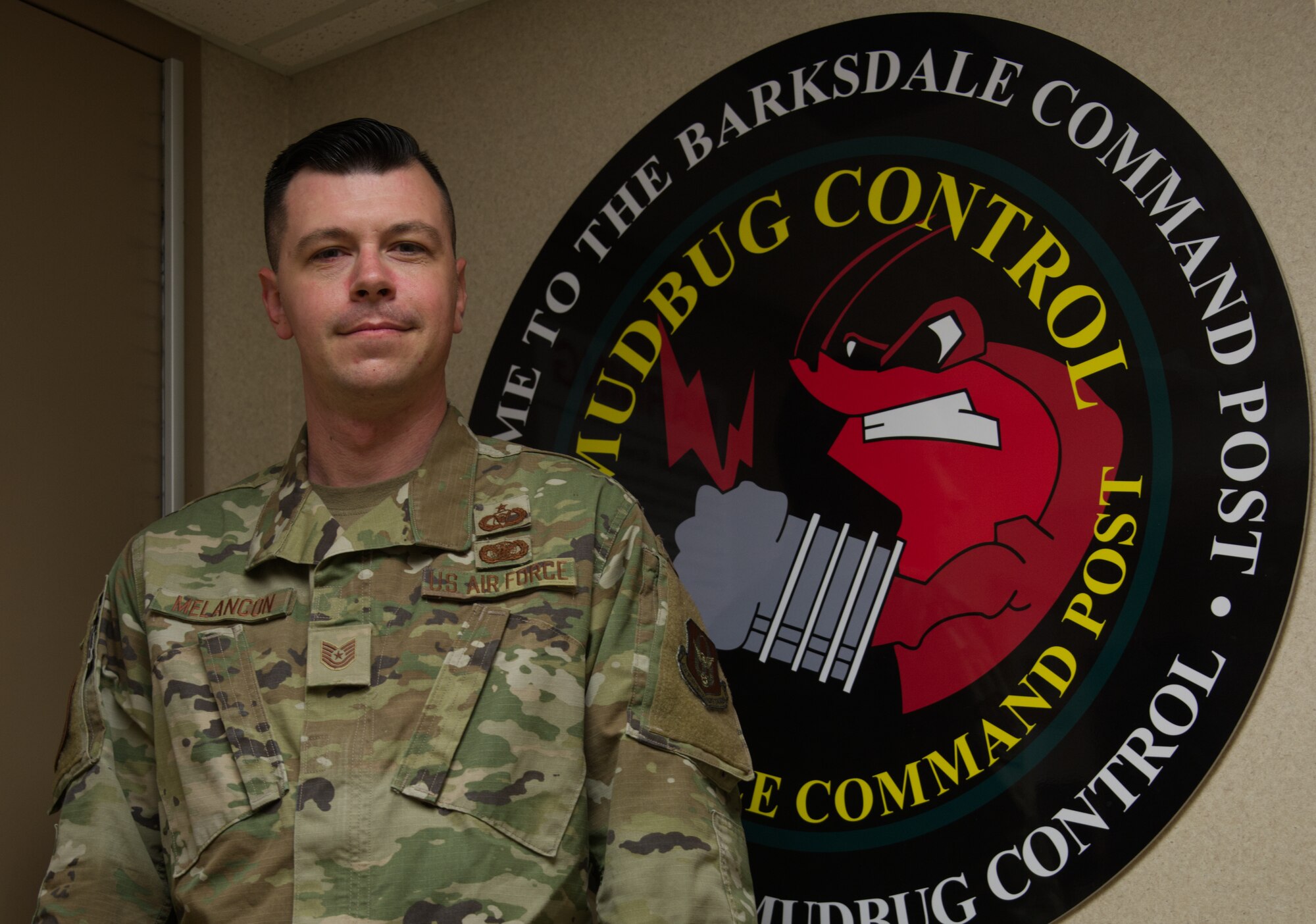 Photo of Airman standing by command post logo
