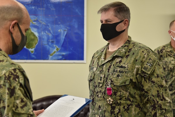 Vice Adm. Bill Merz, left, commander, U.S. 7th Fleet, presents Rear Adm. Fred Kacher with the Legion of Merit during a change of command ceremony for Expeditionary Strike Group (ESG) 7 on Naval Base White Beach. Rear Adm. Chris Engdahl relieved Kacher as the ESG 7 commander.  ESG 7 is forward deployed in the U.S. 7th Fleet area of responsibility to enhance interoperability with allies and partners and serve as a ready response force to defend peace and stability in the Indo-Pacific region.