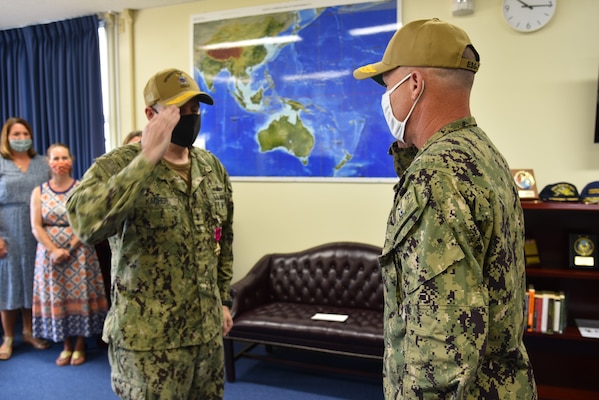 Rear Adm. Fred Kacher, left, salutes Rear Adm. Chris Engdahl, during a change of command ceremony for Expeditionary Strike Group (ESG) 7 on Naval Base White Beach. Engdahl relieved Kacher as the ESG 7 commander. ESG 7 is forward deployed in the U.S. 7th Fleet area of responsibility to enhance interoperability with allies and partners and serve as a ready response force to defend peace and stability in the Indo-Pacific region.