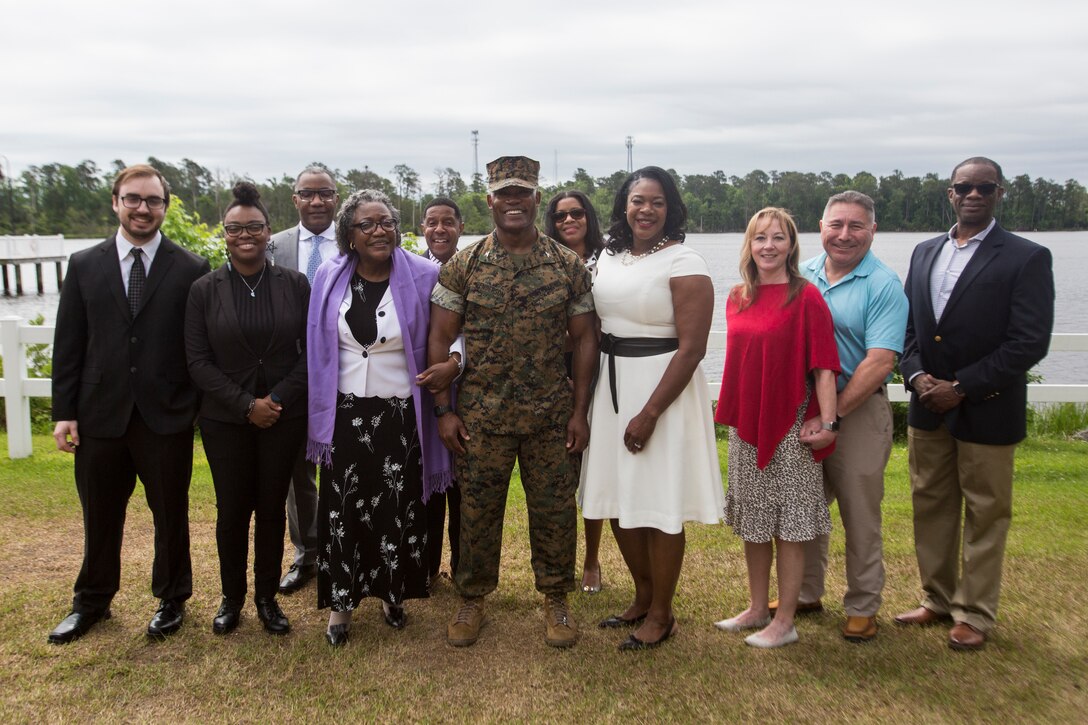 U.S. Marine Corps Brig. Gen. Select Anthony Henderson (Center), the oncoming commander of 2nd Marine Expeditionary Brigade (MEB), II Marine Expeditionary Force, poses for a group photo with his family and friends after a change of command ceremony on Marine Corps Base Camp Lejeune, May 11, 2021. Brig. Gen. Select Henderson took command over 2nd MEB from the previous commander, Col. David Everly. (U.S. Marine Corps photo by Sgt. Jesus Sepulveda Torres)