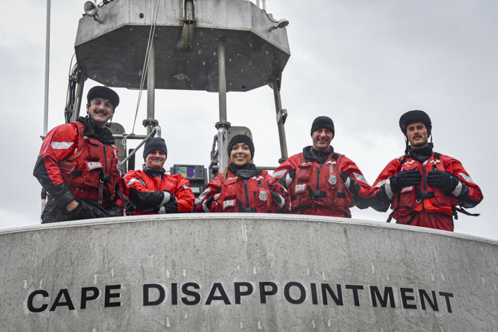 Coast Guard Station Cape Disappointment crew members stand on the stern of a 47-foot Motor Lifeboat after completing drills off the Washington coast, Nov. 14, 2020. The members regularly train in heavy surf near the mouth of the Columbia River so boatcrews are ready to respond in all conditions. (U.S. Coast Guard photo by Petty Officer Steve Strohmaier)