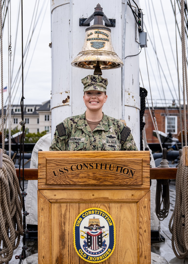 U.S. Navy Petty Officer 1st Class Sara Freeman, a hospital corpsman, assigned to Naval Medical Center Portsmouth, Virginia, stands for a photograph aboard the USS Constitution in the Boston Harbor after her reenlistment ceremony, May 5, 2021.