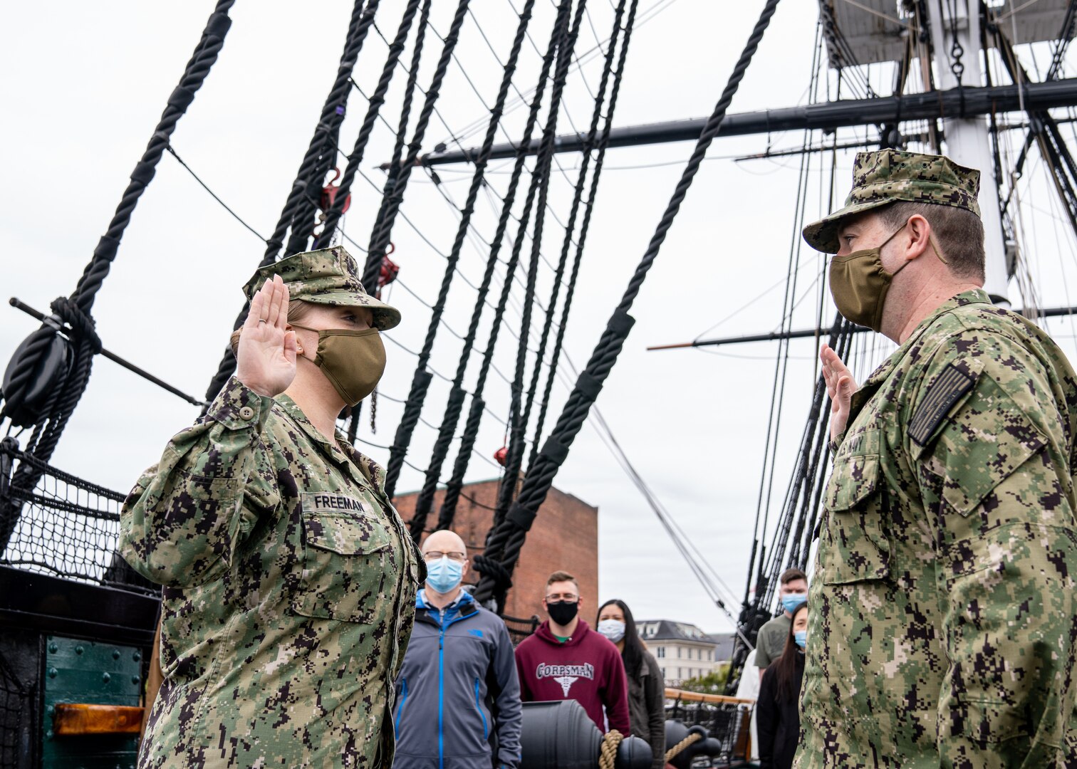 U.S. Navy Petty Officer 1st Class Sara Freeman, a hospital corpsman, assigned to Naval Medical Center Portsmouth, Virginia, is given the Oath of Enlistment by U.S. Navy Lt. Brian Gluckman, a perioperative nurse, aboard the USS Constitution in the Boston Harbor, May 5, 2021.