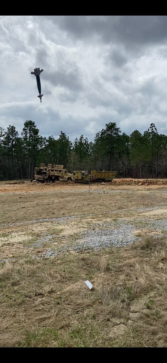An inert Joint Direct Attack Munition (JDAM) bomb drops at the Camp Shelby Air-to-Ground Range, also known as the Rattlesnake Range in Perry County, Miss., March 2021.