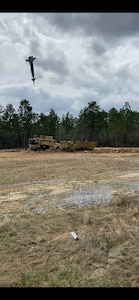 An inert Joint Direct Attack Munition (JDAM) bomb drops at the Camp Shelby Air-to-Ground Range, also known as the Rattlesnake Range in Perry County, Miss., March 2021.