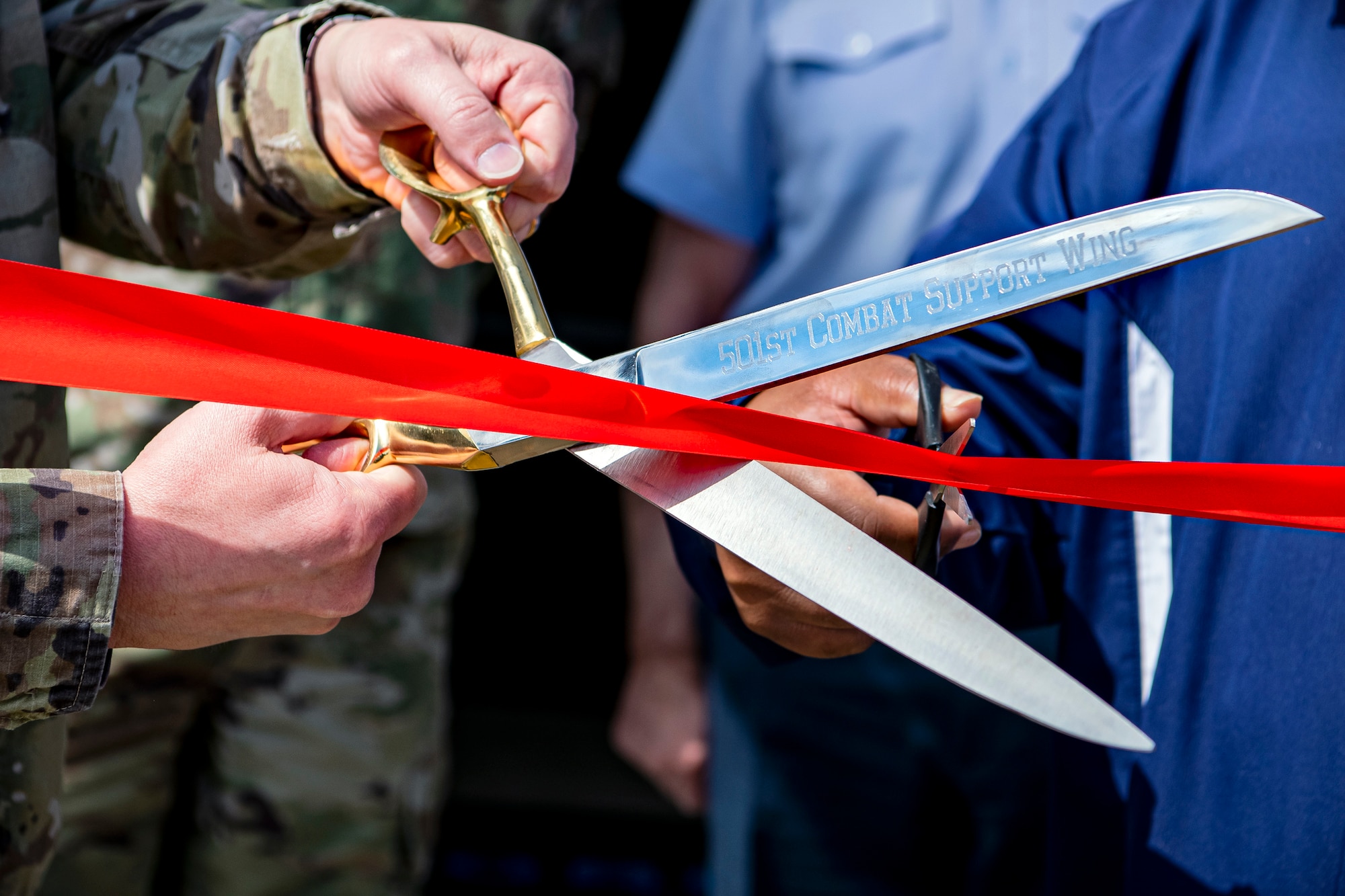 Leadership from the 501st Combat Support Wing prepare to cut a ribbon at RAF Molesworth, England, May 11, 2021. Leadership from RAF Alconbury and RAF Molesworth attended the ceremony to celebrate the reopening of the base gym after months of refurbishing and renovations. (U.S. Air Force photo by Senior Airman Eugene Oliver)