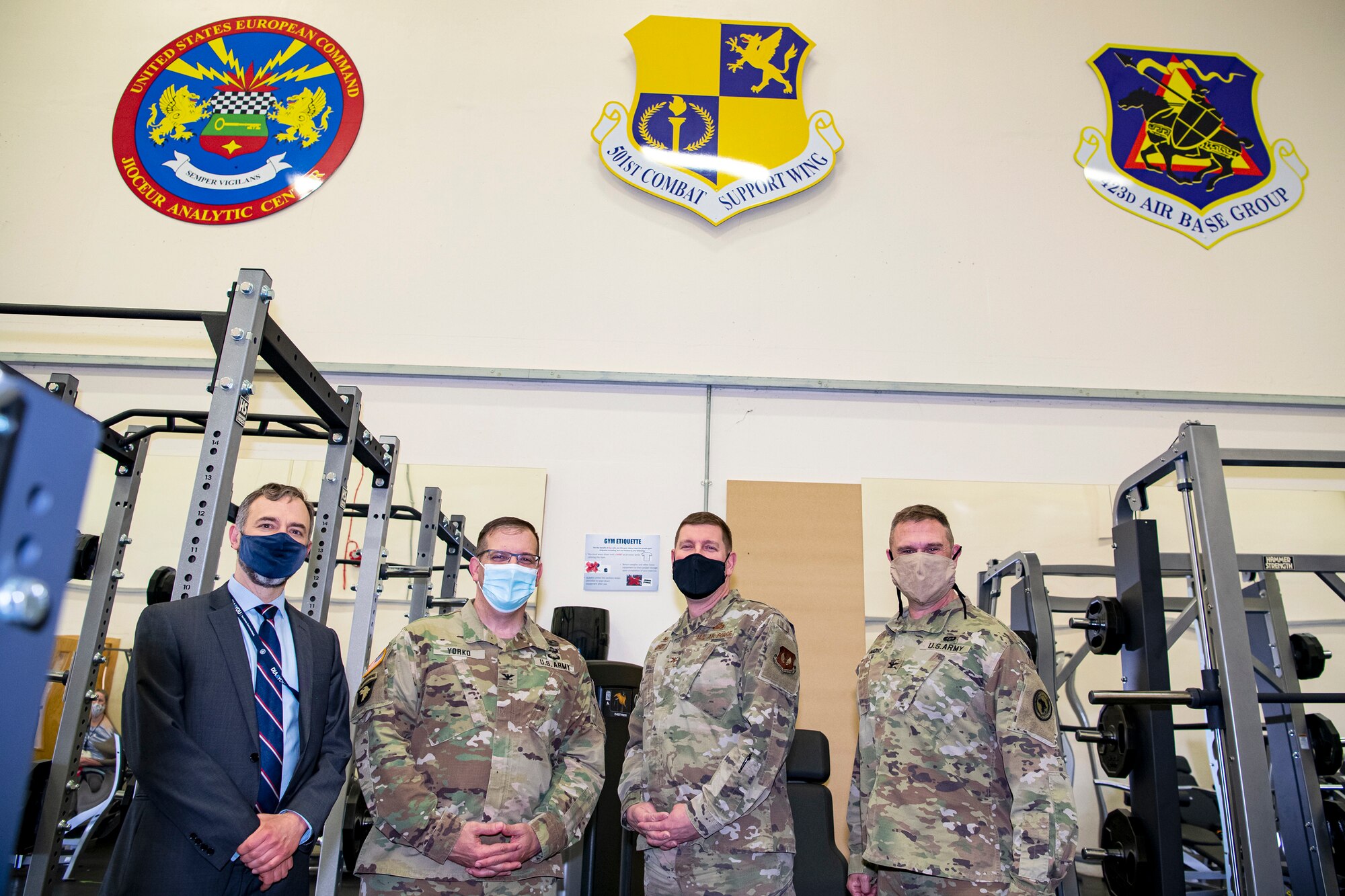 Jordan Rankin, left, Joint Intelligence Operations Center Europe Analytic Center, U.S. Army Col. John Yorko, center left, NATO Intelligence Fusion Centre commander, U.S. Air Force Col. Kurt Wendt, center right, 501st Combat Support Wing commander, Army Col. Brian Dunmire U.S. Africa Command Directorate for Intelligence at RAF Molesworth multi-service commander, pose for a photo inside the renovated fitness center at RAF Molesworth, England, May 11, 2021. Leadership from RAF Alconbury and RAF Molesworth attended a ribbon cutting ceremony to celebrate the reopening of the base gym after months of refurbishing and renovations. (U.S. Air Force photo by Senior Airman Eugene Oliver)