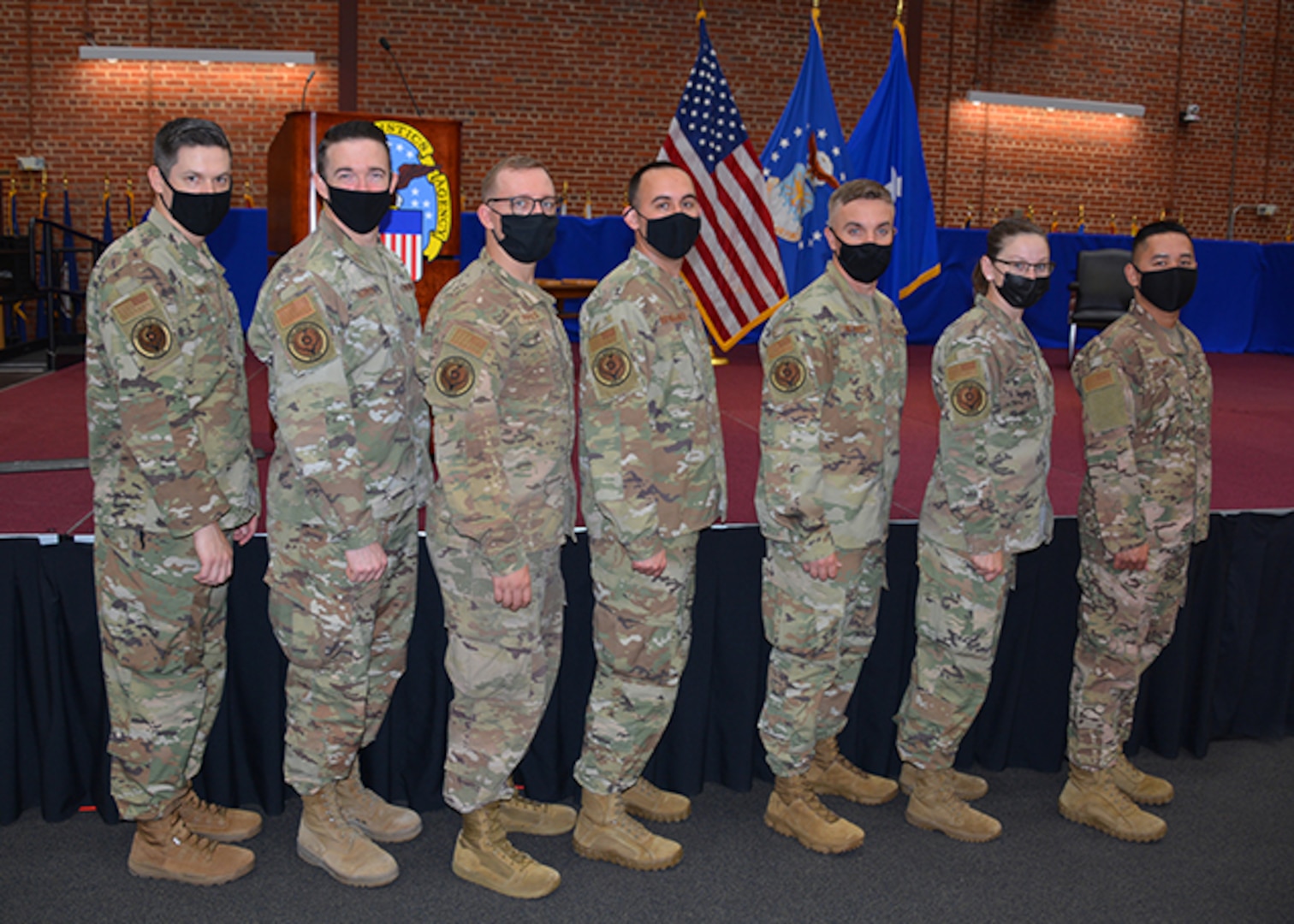 Airmen pose to display new unit patch.