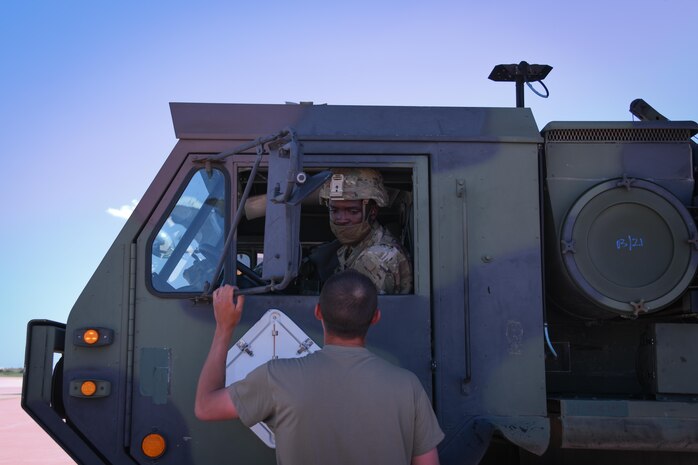 person talks to a person in vehicle