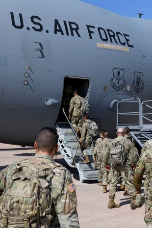 people walk onto aircraft