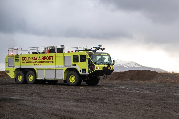U.S. Marine Corps expeditionary firefighting and rescue specialists with Marine Wing Support Detachment, Marine Medium Tiltrotor Squadron, 15th Marine Expeditionary Unit and Cold Bay Airport rescue firefighters maneuver an Oshkosh Striker T3000 firetruck into position in preparation for a training event at Cold Bay airport, Alaska in support of Northern Edge 2021. U.S. service members are participating in a joint training exercise hosted by U.S. Pacific Air Forces May 3-14, 2021, on and above the Joint Pacific Alaska Range Complex, the Gulf of Alaska, and temporary maritime activities area. NE21 is one in a series of U.S. Indo-Pacific Command exercises designed to sharpen the joint forces’ skills; to practice tactics, techniques, and procedures; to improve command, control and communication relationships; and to develop cooperative plans and programs.