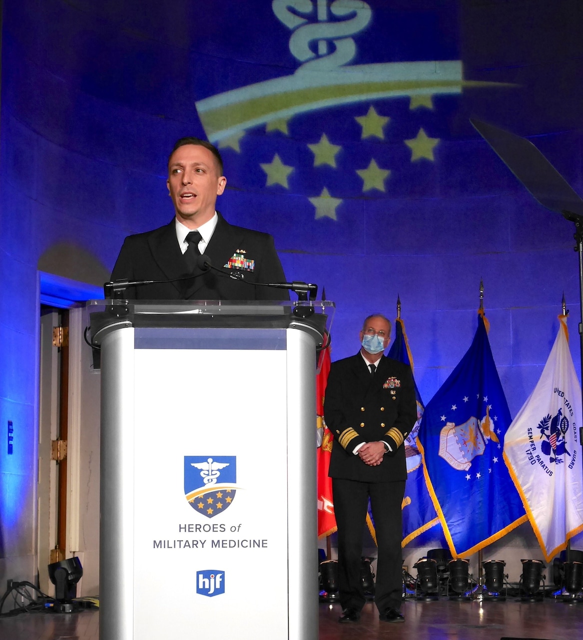 Lt. Cmdr. Matthew Hall accepts the 2021 Navy Hero of Military Medicine Award.