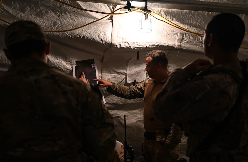 U.S. Air Force members of the 322nd Base Defense Squadron, Moody Air Force Base, Georgia, review a map during the Agile Flag 21-2 experiment at Naval Outlying Landing Field Choctaw, Florida, May 3, 2021. The 322nd BDS is one of several units participating in Agile Flag, an experiment that tests a wing’s ability to deploy into a theater as a lead air expeditionary wing. (U.S. Air Force photo by Senior Airman Sarah Dowe)