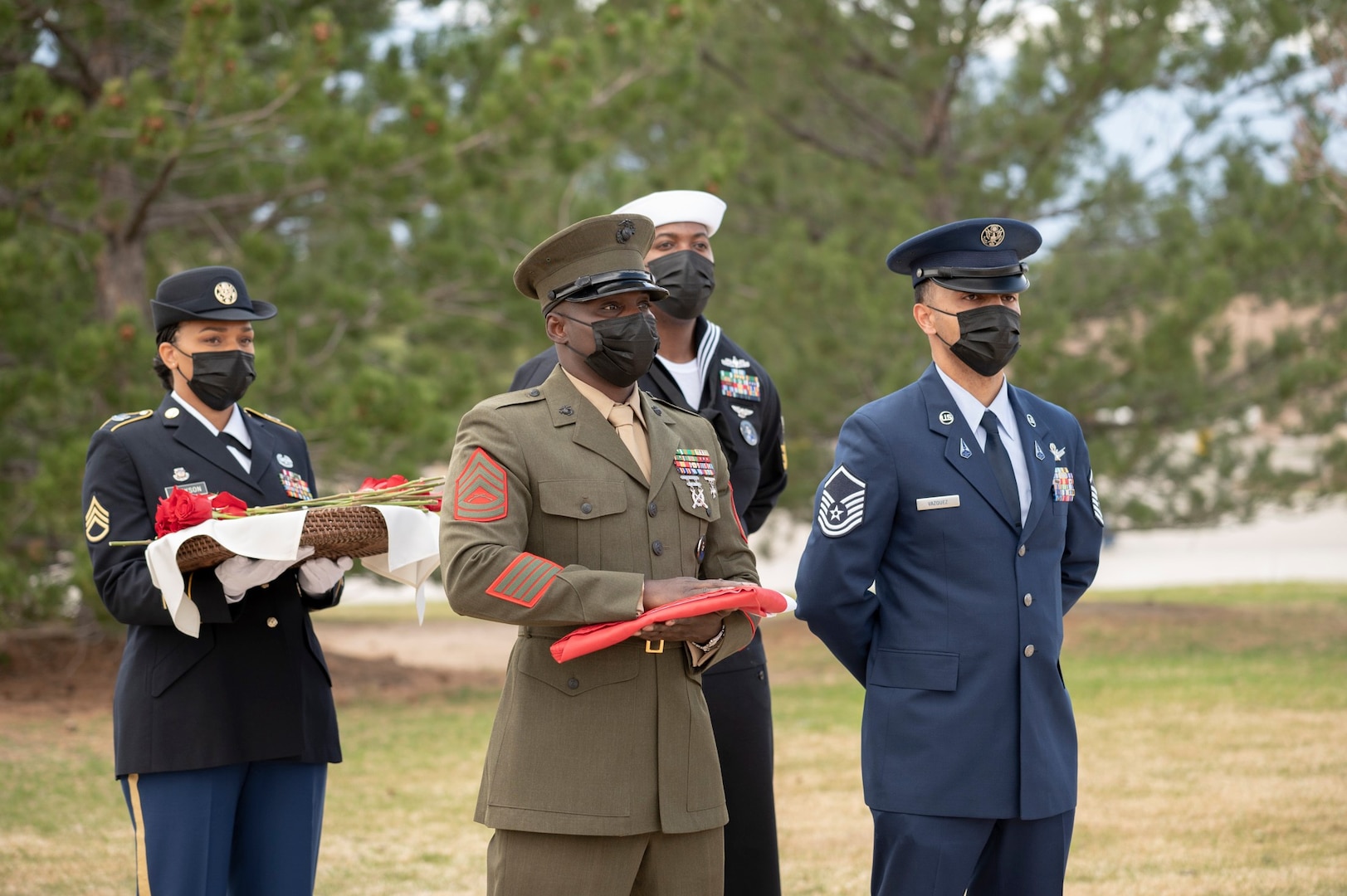 United States Space Command service members await the start of the Gold Star flag raising ceremony May 7 outside USSPACECOM headquarters at Peterson Air Force Base, Colorado. Each family was given a single remembrance rose to place at the base of the Gold Star flagpole in memory of their service member.