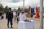 Gold Star families from Colorado’s Front Range place remembrance roses at the base of the flagpole May 7 during a Gold Star flag raising ceremony at Peterson Air Force Base, Colorado. Each rose represented a fallen service member.