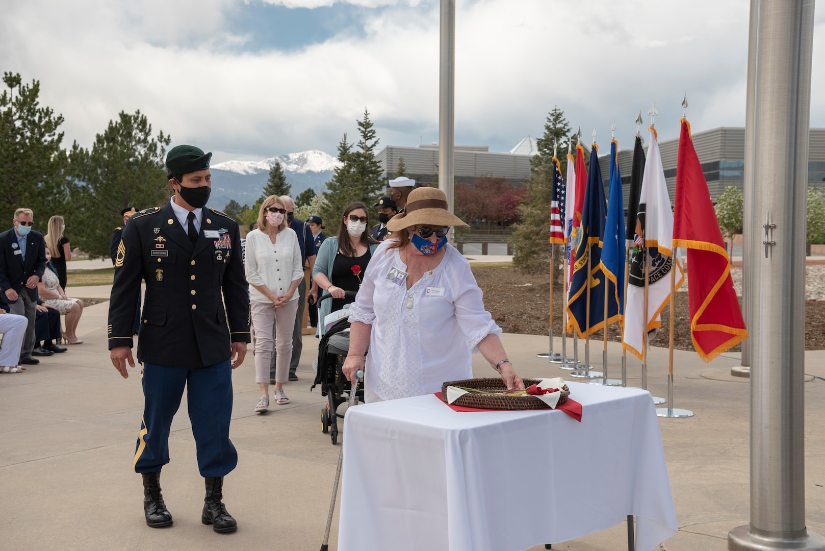 Gold Star families from Colorado’s Front Range place remembrance roses at the base of the flagpole May 7 during a Gold Star flag raising ceremony at Peterson Air Force Base, Colorado. Each rose represented a fallen service member.