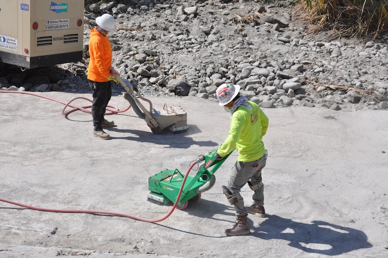 Workers tamp down earth in preparation of laying a harder surface to repair a toe road on the bed of the Los Angeles River for an Army Corps of Engineers Los Angeles District maintenance project, May 4. The tow roads will be submerged again after the project is completed. The original road was built in 1939.