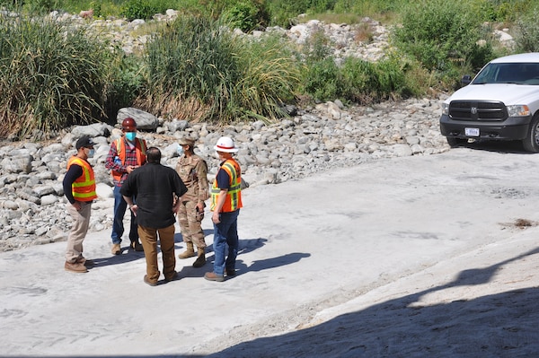 In the burgundy helmet, Contractor Jordan Soto of Rio Jordan Construction conducts an overview and safety briefing about the toe road maintenance project for Corps’ District program manager Lt. Col. Malia Pearson and her team, May 4, on the toe road in the Los Angeles River.