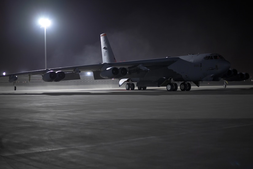 A bomber aircraft taxis into position at night.