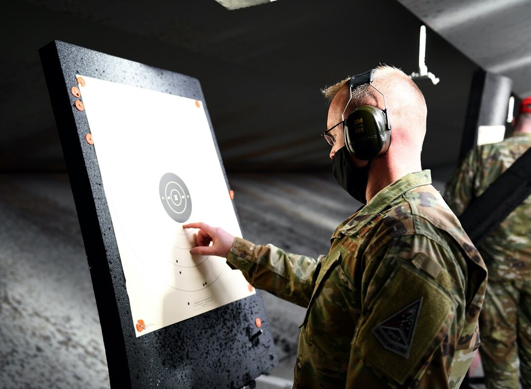 U.S. Air Force Col. Brian Chellgren, acting Buckley Garrison commander, checks out his target after the first practice round at a shooting competition on Buckley Air Force Base, Colo., May 11, 2021. The 460th Security Forces Squadron Combat Arms team held the shooting competition in honor of National Police Week. (U.S. Space Force photo by Airman 1st Class Haley N. Blevins)