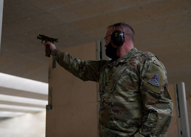 U.S. Air Force Col. Brian Chellgren, acting Buckley Garrison commander, fires a handgun at a shooting competition on Buckley Air Force Base, Colo., May 11, 2021. The 460th Security Forces Squadron Combat Arms team held the shooting competition in honor of National Police Week. (U.S. Space Force photo by Airman 1st Class Haley N. Blevins)