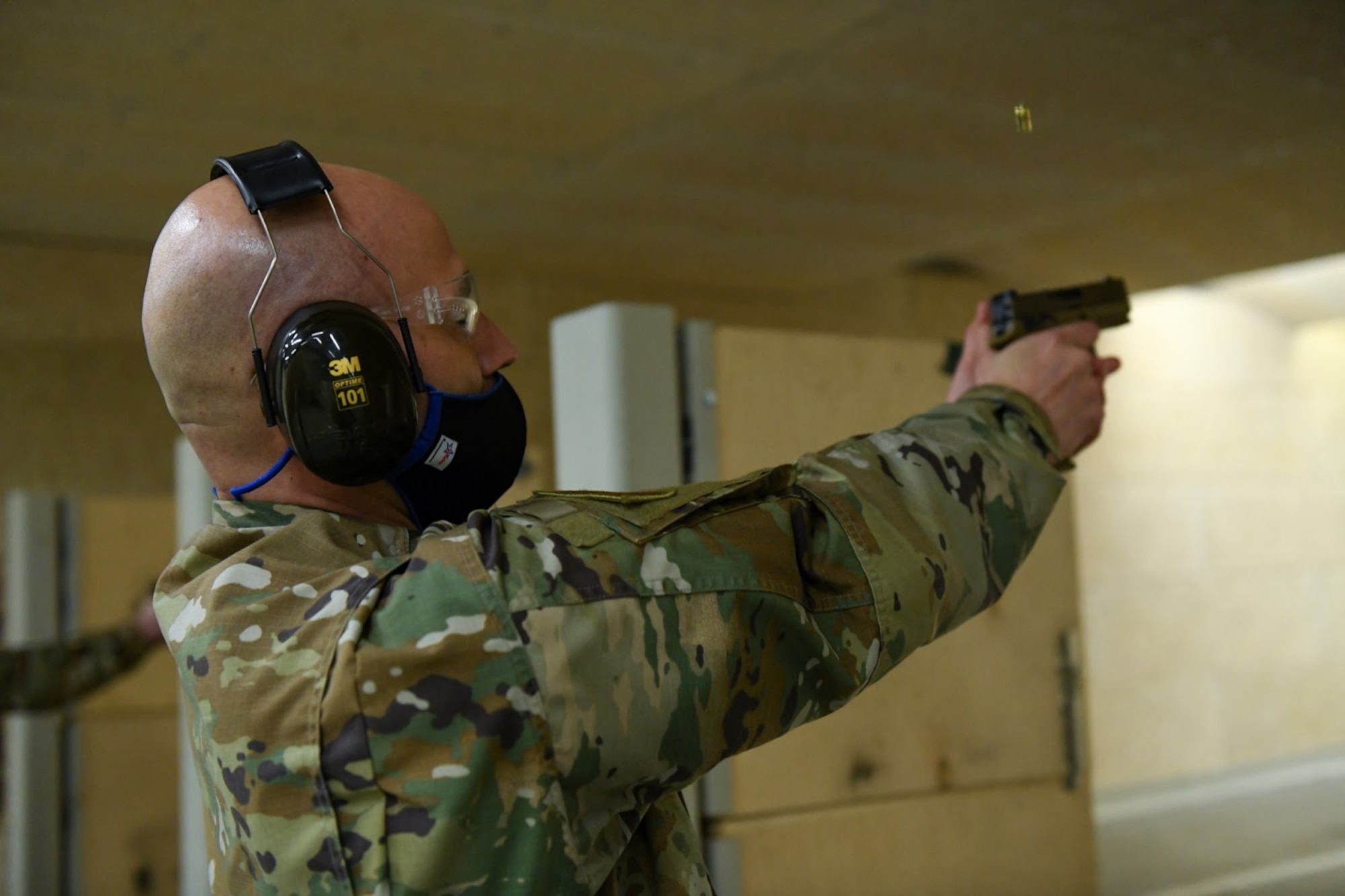 U.S. Air Force Chief Master Sgt. Robert Devall, Buckley Garrison command chief, fires a round down range at Buckley Air Force Base, Colo., on May 11, 2021. Devall took part in a shooting competition held by the 460th Security Forces Squadron Combat Arms team as a part of National Police Week. (U.S. Space Force photo by Airman Shaun Combs)