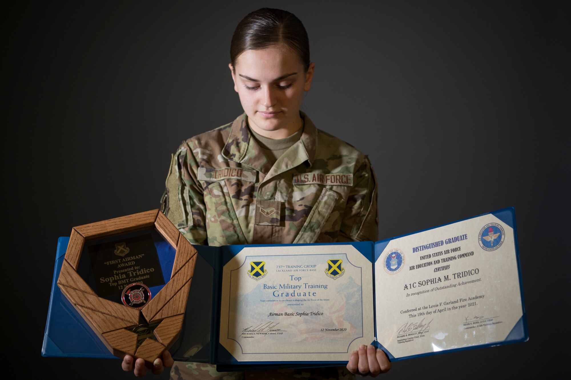 Photo of airman holding awards