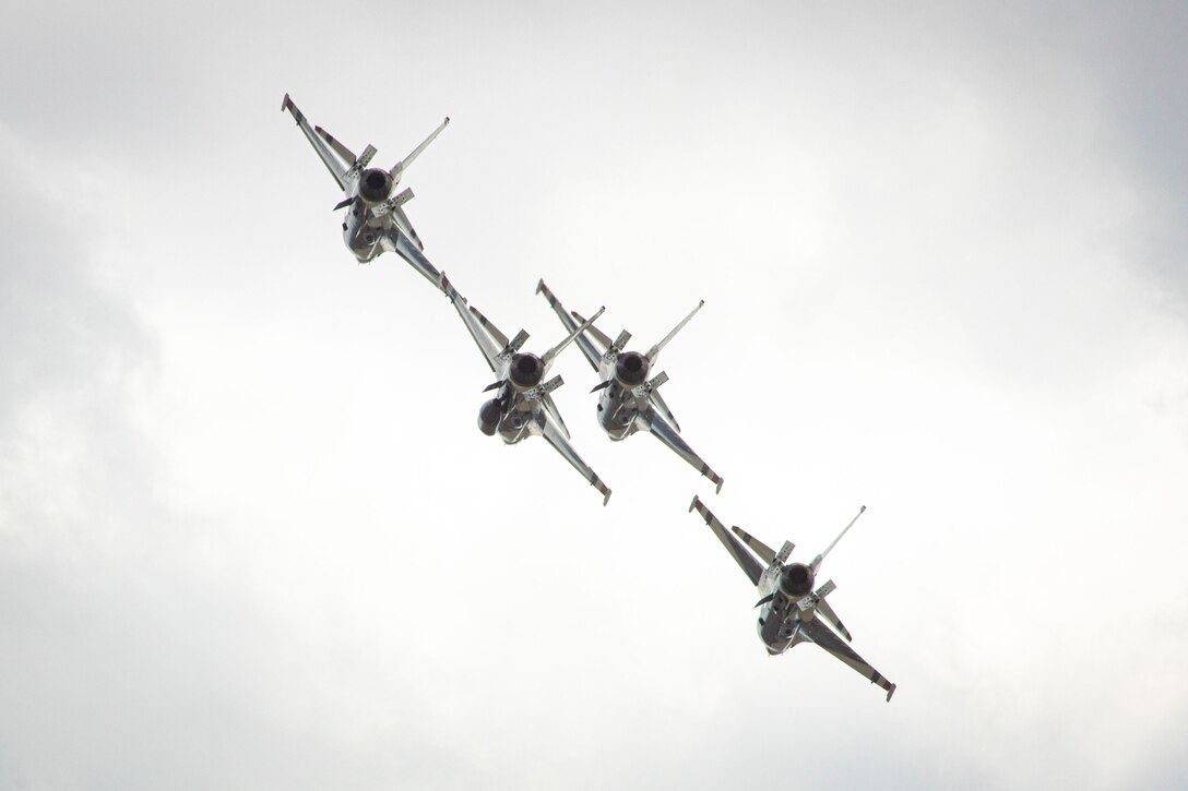 Four Air Force aircraft fly in formation.