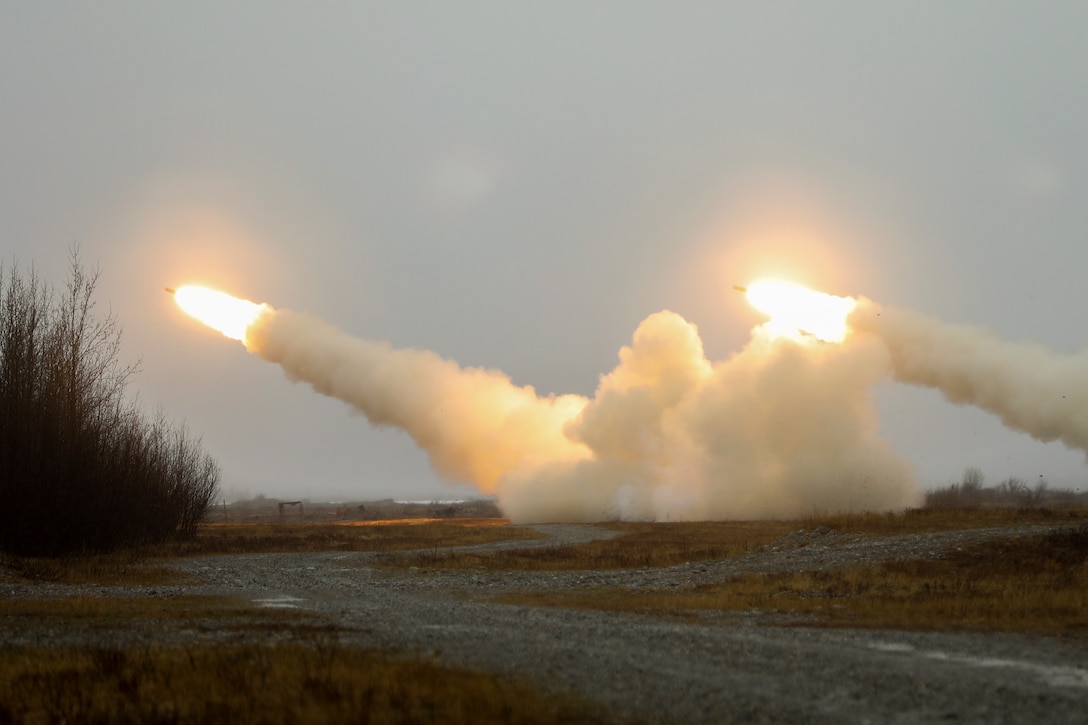 Rockets launch in a field.