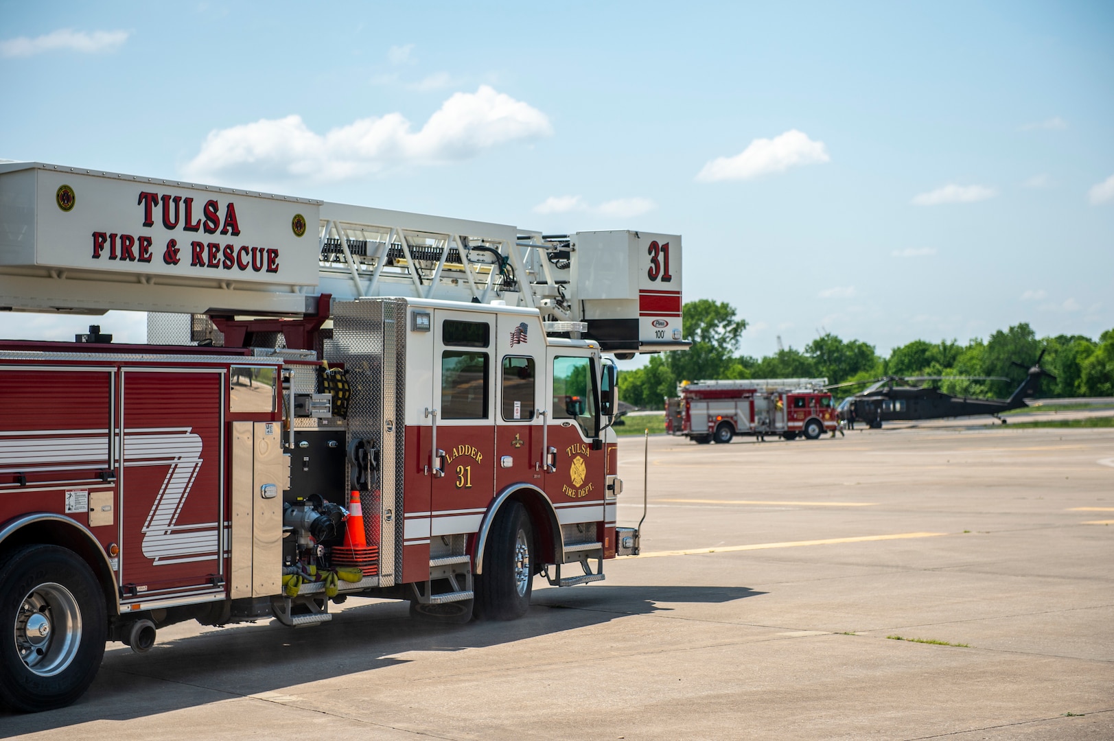 Vehicles from the Tulsa, Oklahoma Fire Department arrive on the scene of a simulated UH-60 Black Hawk crash during pre-accident training at the Oklahoma Army National Guard's Army Aviation Facility 2 in Tulsa, Oklahoma, May 12, 2021. Pre-accident training prepares Army aviation units to respond to accidents ranging from slip and falls to mass casualty events. (Oklahoma National Guard photo by Anthony Jones)