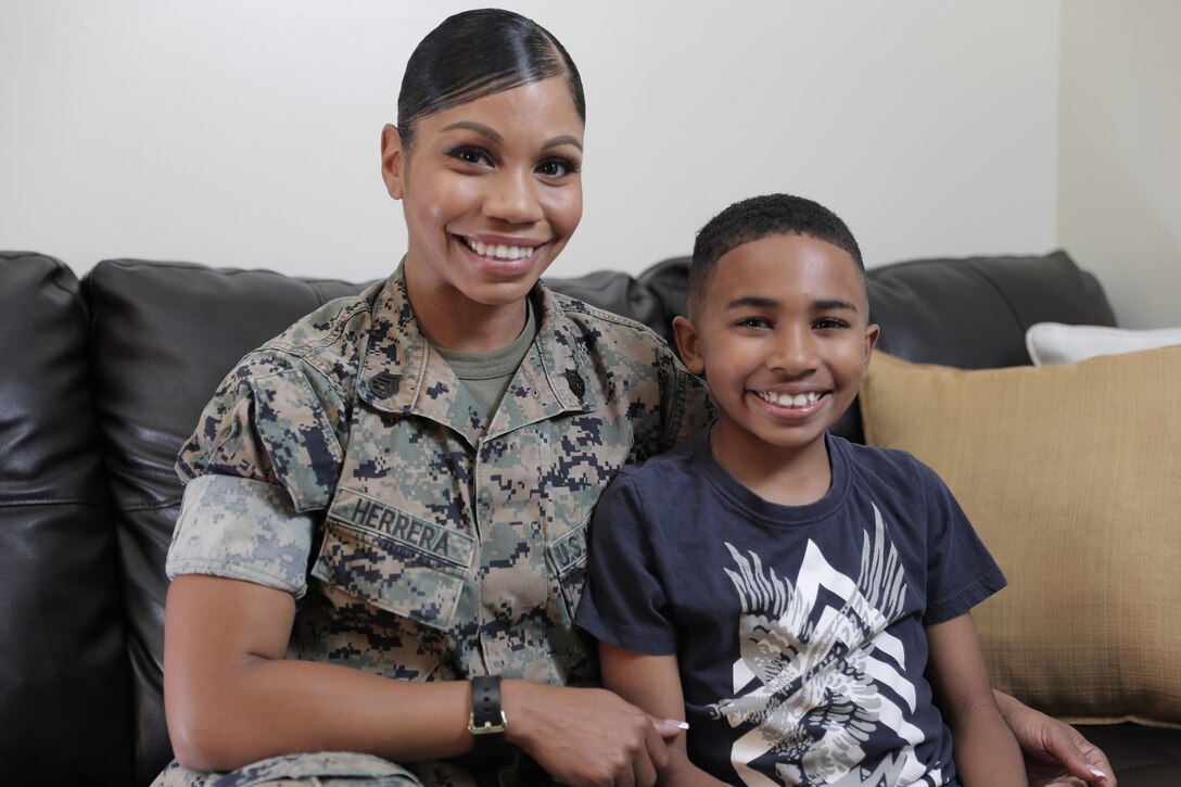 U.S. Marine Corps Staff Sgt. Spendia T. Herrera, a distribution management chief at 3rd Marine Expeditionary Brigade, and her son, Carmelo, pose for a photo on Camp Shields, Okinawa, Japan, April 26, 2021. (U.S. Marine Corps photo by Cpl. Francesca Landis)