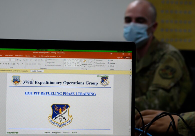 Senior Airman Scott Fure, 379th Expeditionary Maintenance Squadron C-130 crew chief, listens to an instructor during the classroom portion of “hot pit” refueling training, Prince Sultan Air Base, Kingdom of Saudi Arabia, April 28, 2021. Hot pit refueling is where maintainers refuel an aircraft while the engine is still running, allowing the aircraft to safely and quickly return to flying. (U.S. Air Force Photo by Senior Airman Samuel Earick)