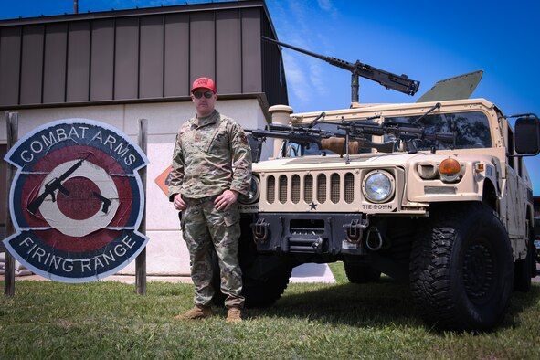 airmen poses in front of hummer